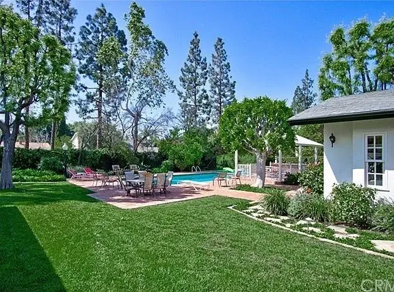 Outdoor pool with swimming pool, patio furniture, gazebo, and greenery
