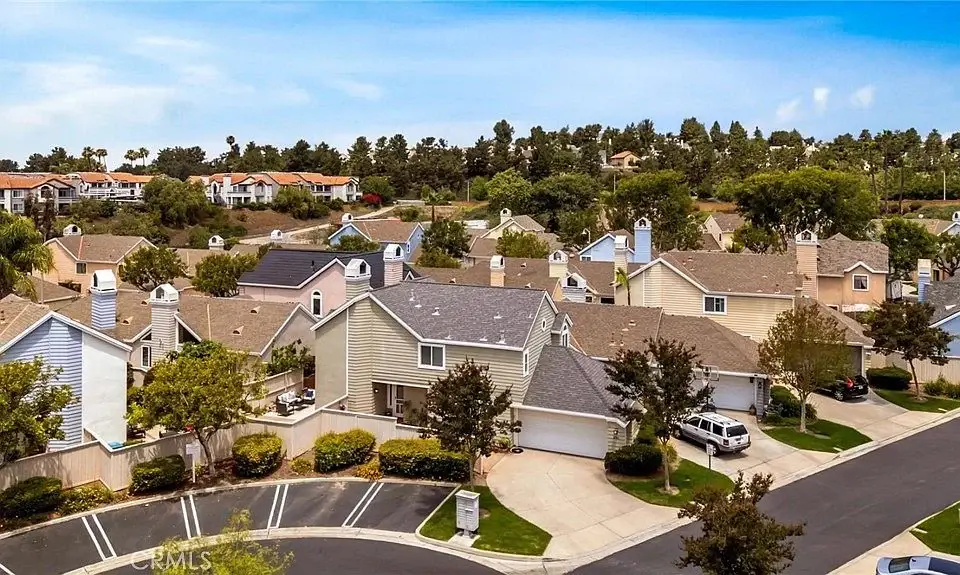 Aerial view of suburban houses California real estate with trees and streets.
