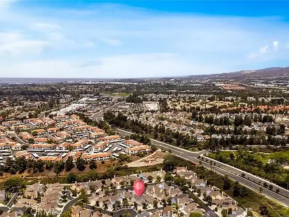 Aerial view of suburban houses, roads, and open spaces in California real estate.