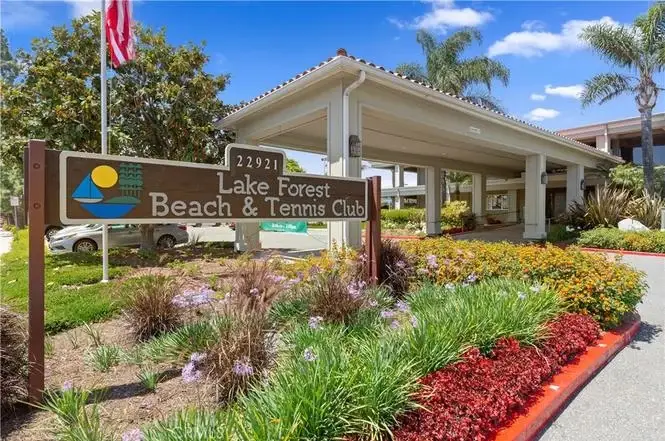 Lake Forest Beach & Tennis Club with flowers and palm trees.