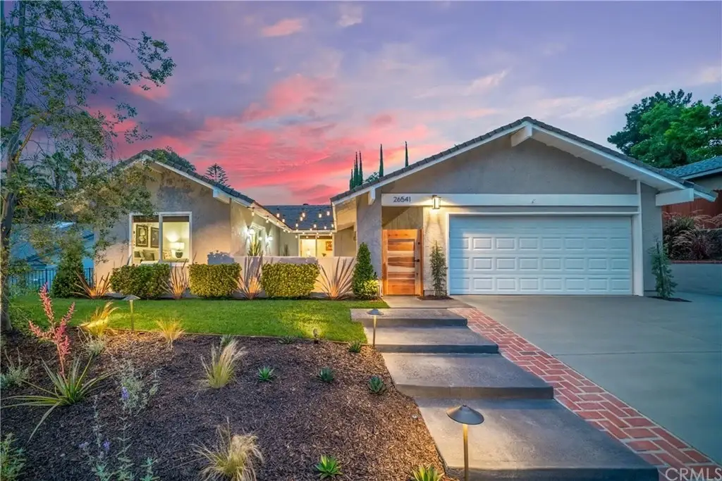 Contemporary house, California real estate, with front yard, garage, and brick driveway