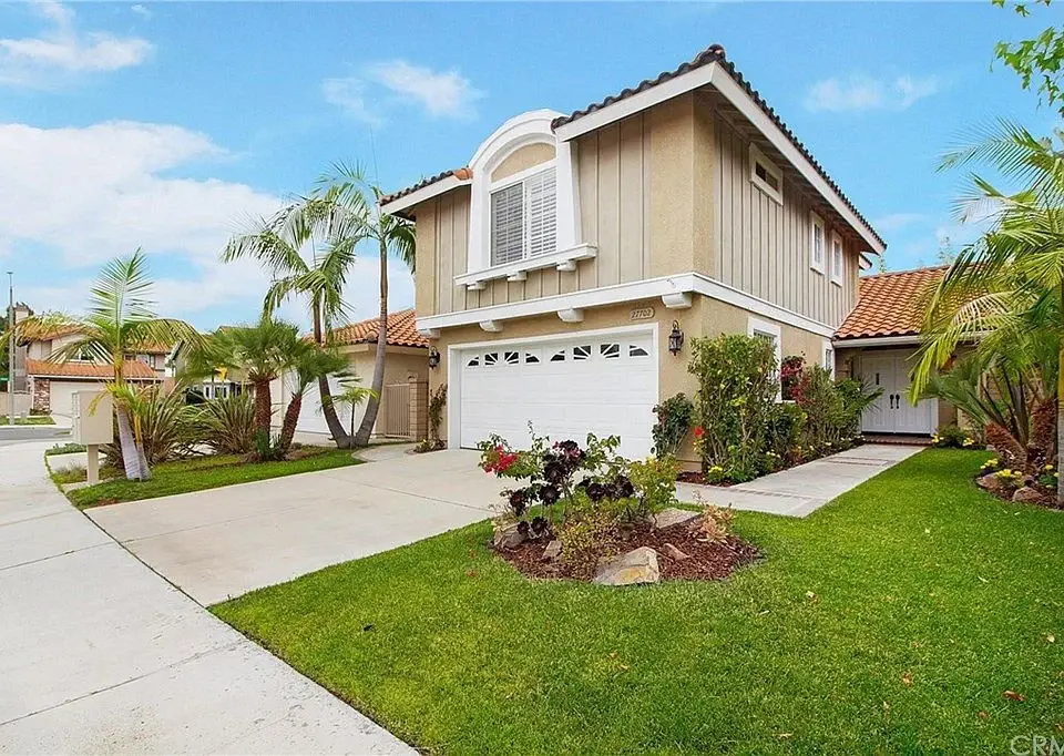 Luxury home in California real estate with a two-story stucco exterior and a double garage.