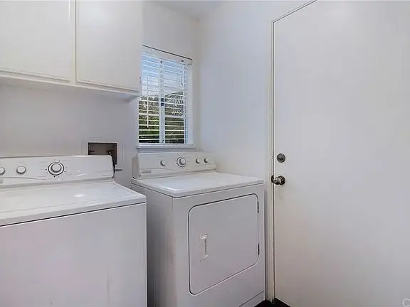 Laundry room with washer, dryer, window and a door