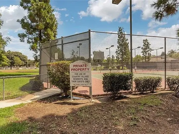Tennis court with fence and sign saying Private Property for residents and guests.