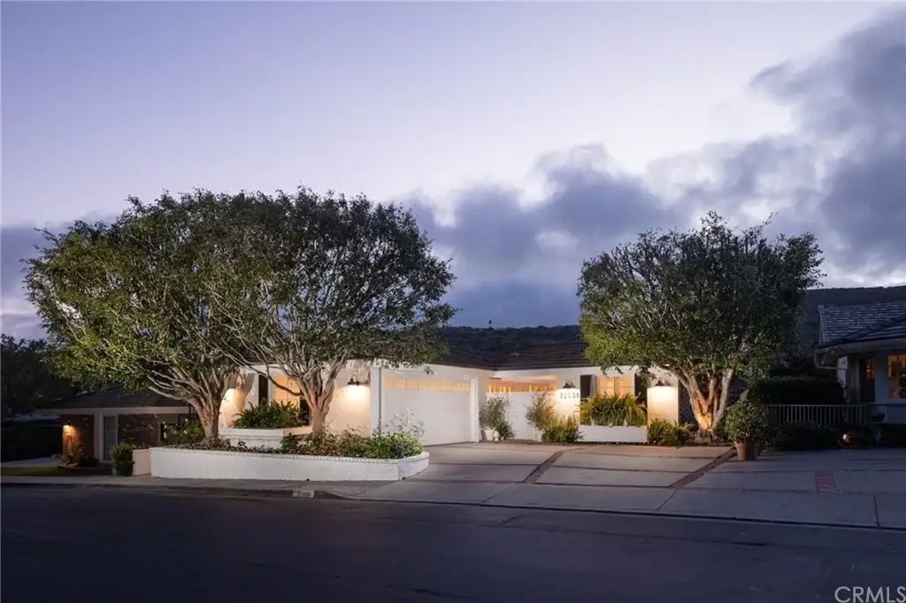 House California real estate with trees and exterior lights.
