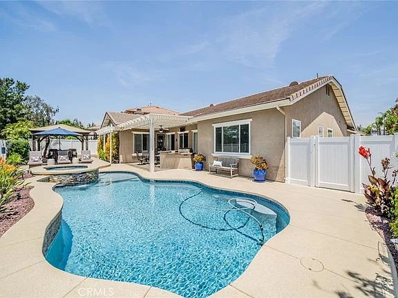 Outdoor seating area with table, chairs, and greenery