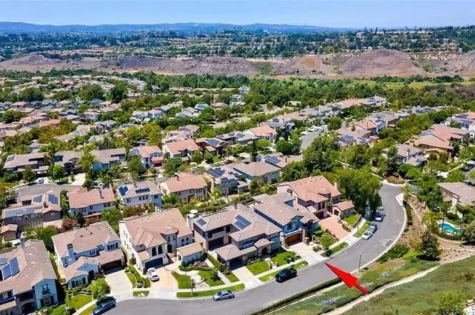 Aerial view of houses California real estate with streets and greenery.