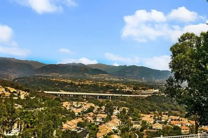 Panoramic view of houses California real estate with mountains, highway